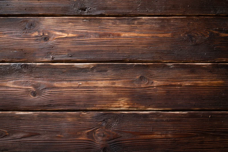 Close-up of aged horizontal wooden planks showing natural grain and knots as a textured surface