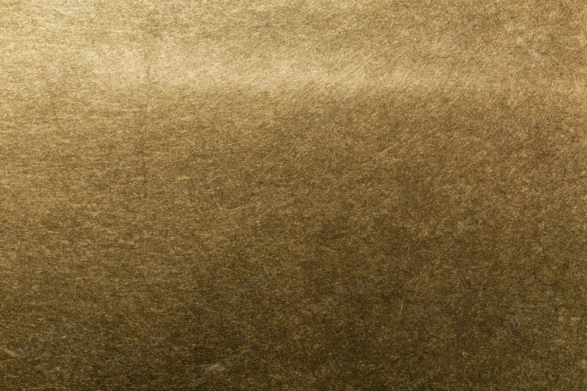 Close-up of aged brass metal surface with textured patina and warm golden tones