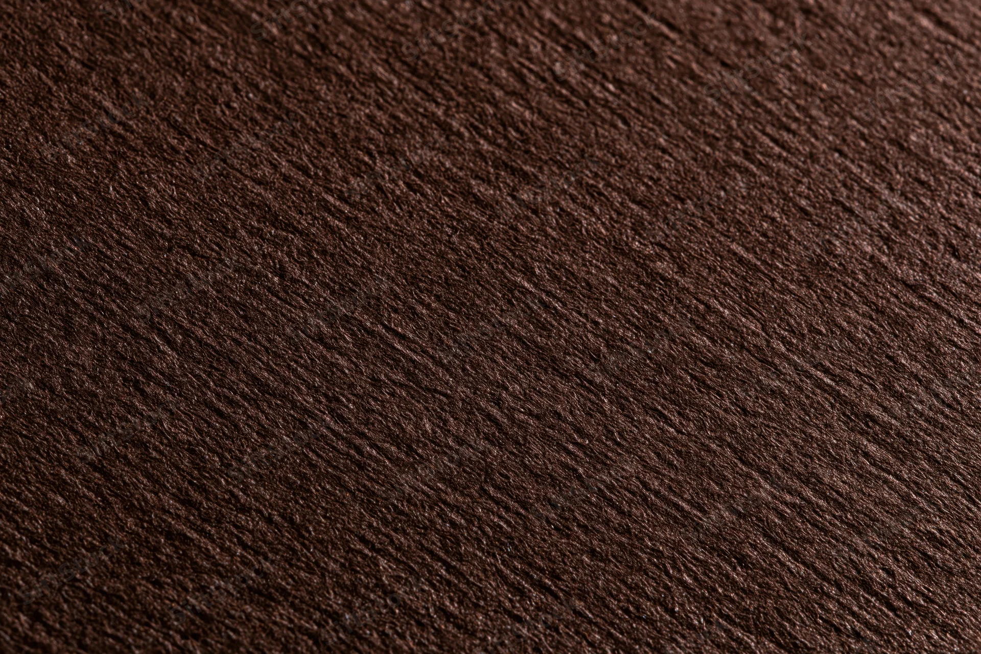 Close-up of dark brown textured cardstock paper surface in flat lay arrangement