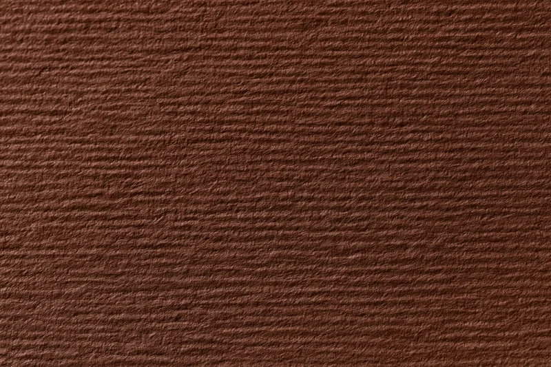 Close-up flat lay of dark brown textured cardstock paper surface