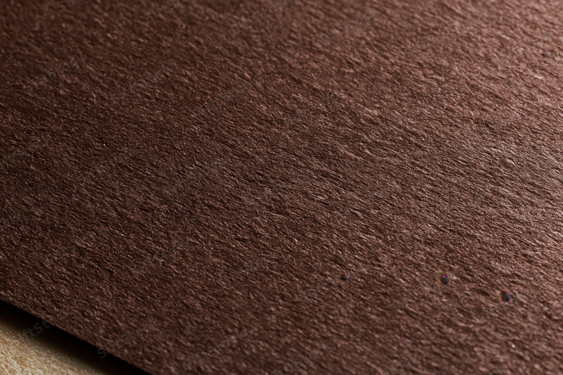 Close-up of dark brown textured cardstock paper surface in flat lay arrangement