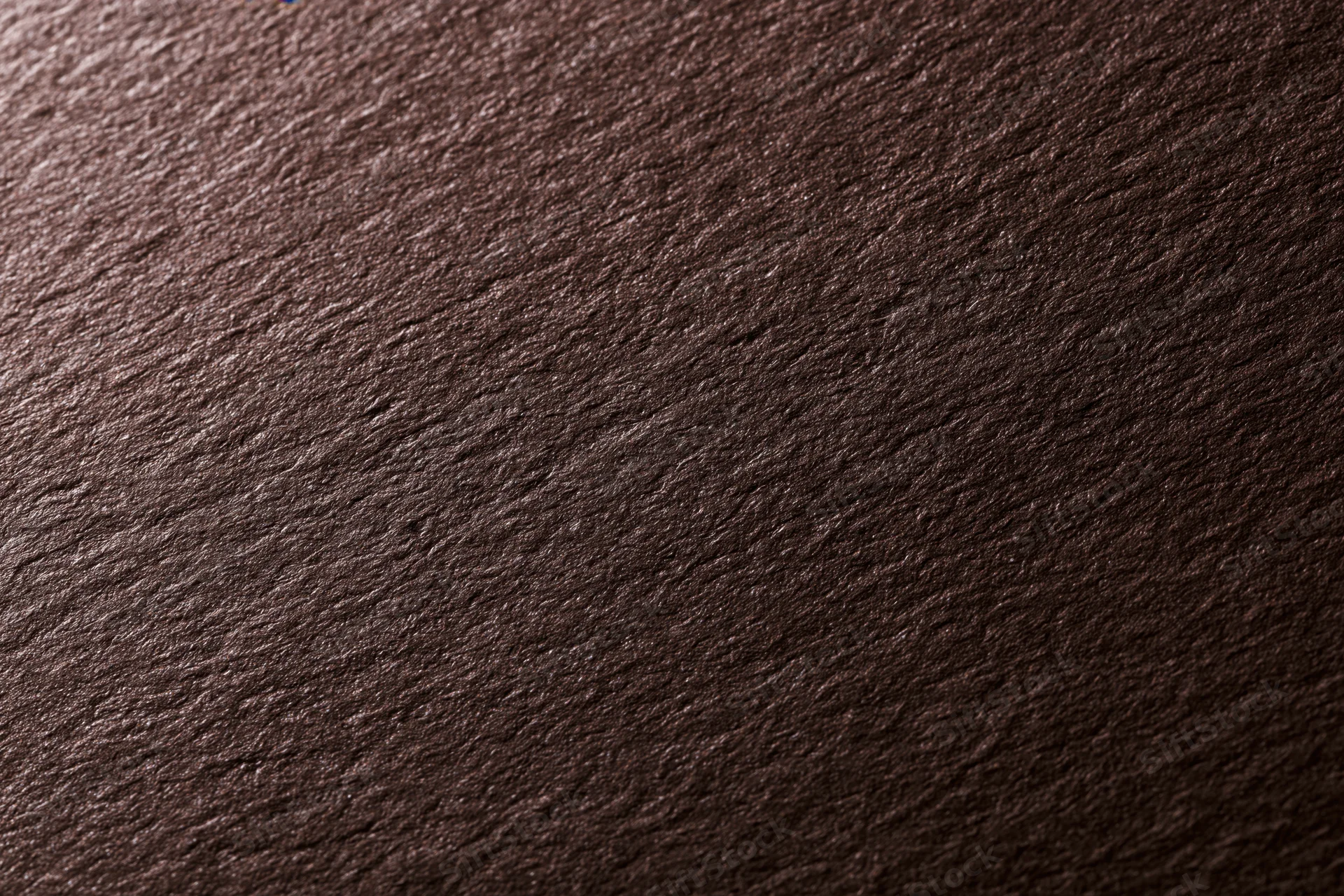 Close-up of dark brown textured cardstock paper surface in flat lay arrangement