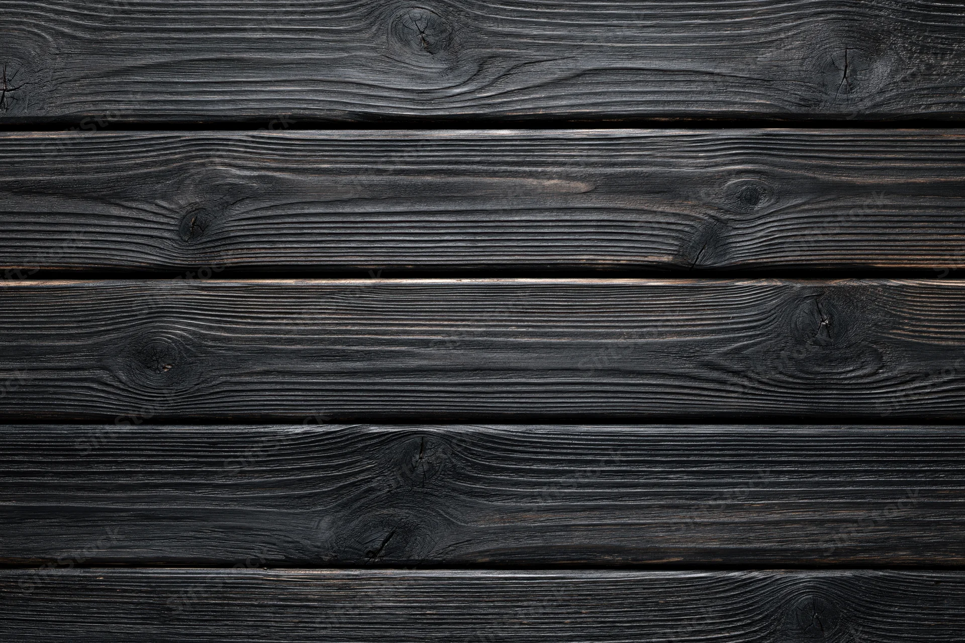 Dark charred wooden planks arranged horizontally as a textured surface