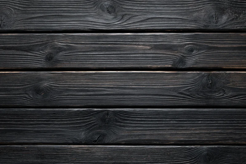 Dark charred wooden planks arranged horizontally as a textured surface
