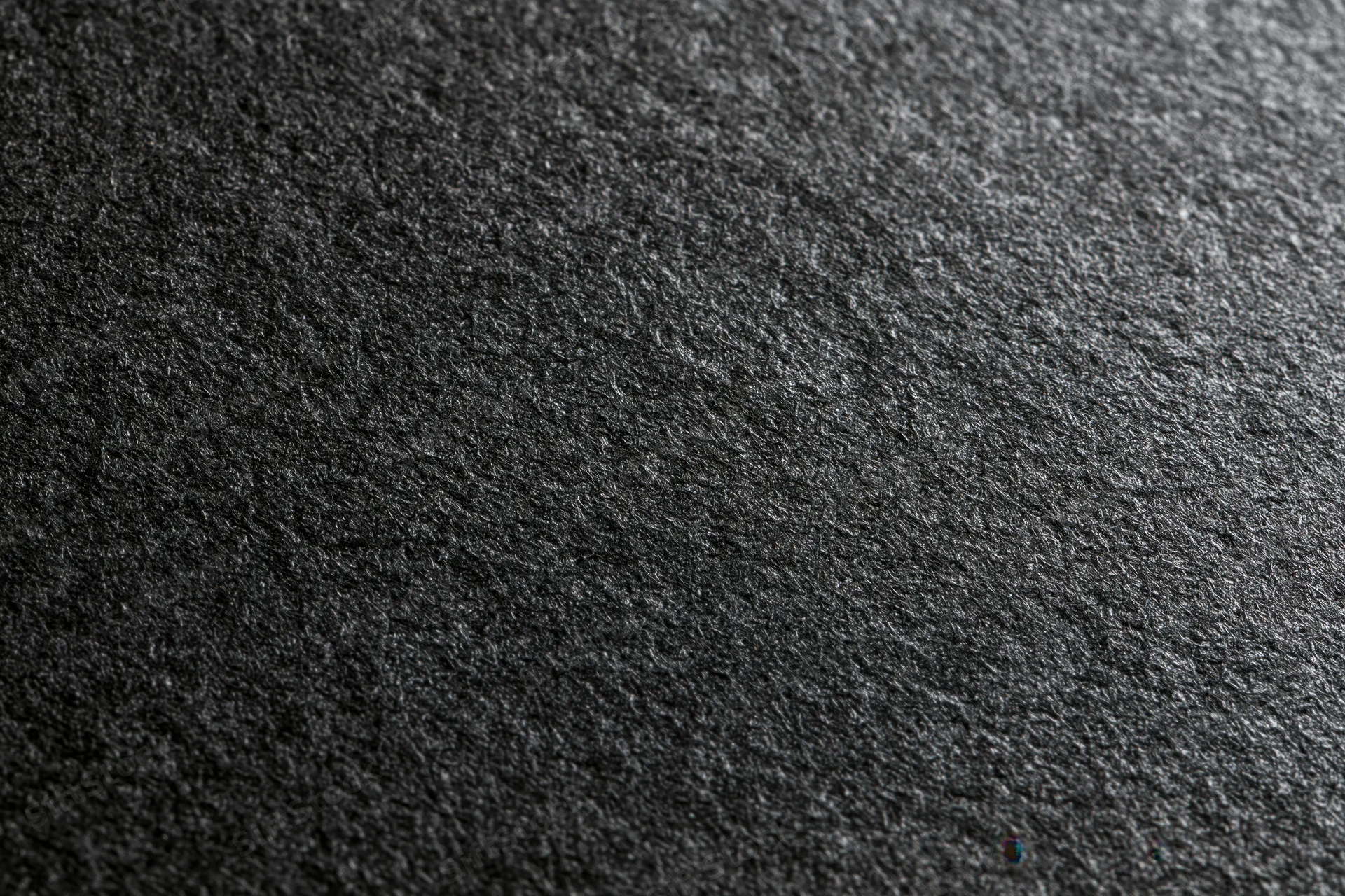 Close-up of dark charcoal black textured paper surface in flat lay arrangement