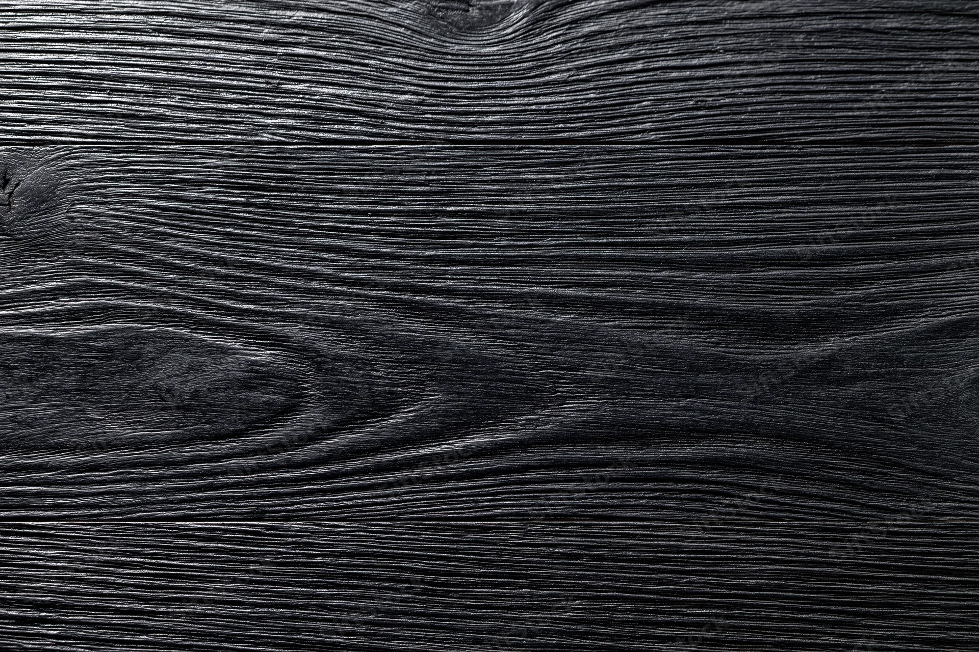 Close-up of dark charcoal wood surface showing natural grain and texture
