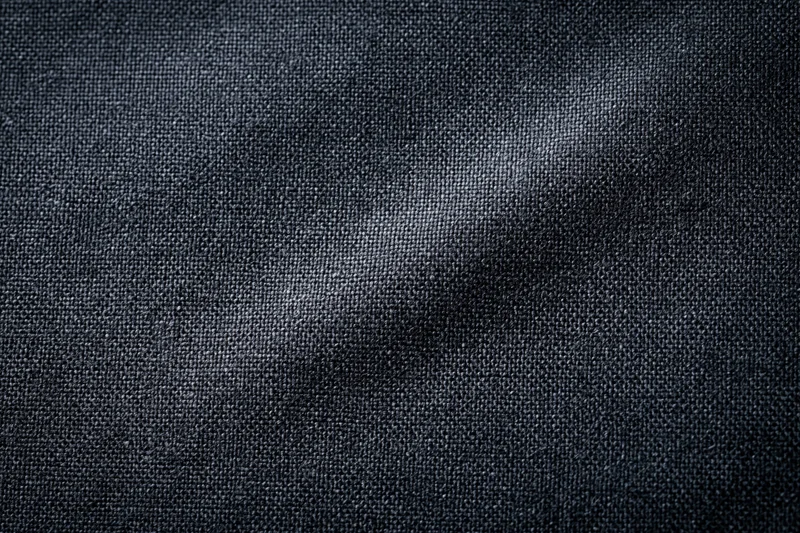 Close-up of dark charcoal woven fabric texture filling the frame