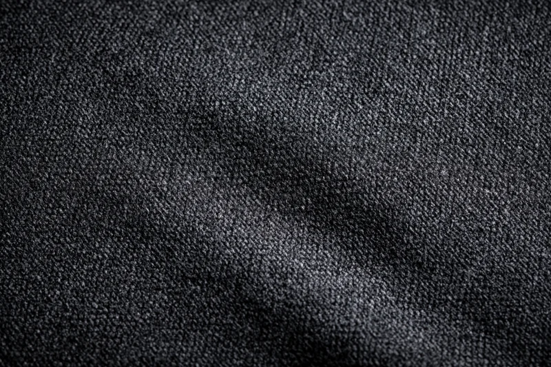 Close-up of dark charcoal woven fabric texture filling the frame