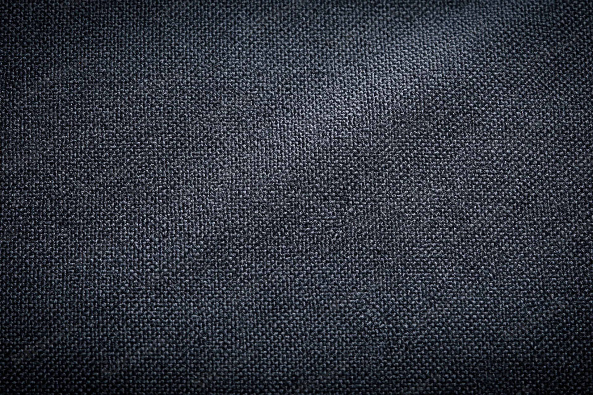Close-up of dark charcoal woven fabric texture filling the frame