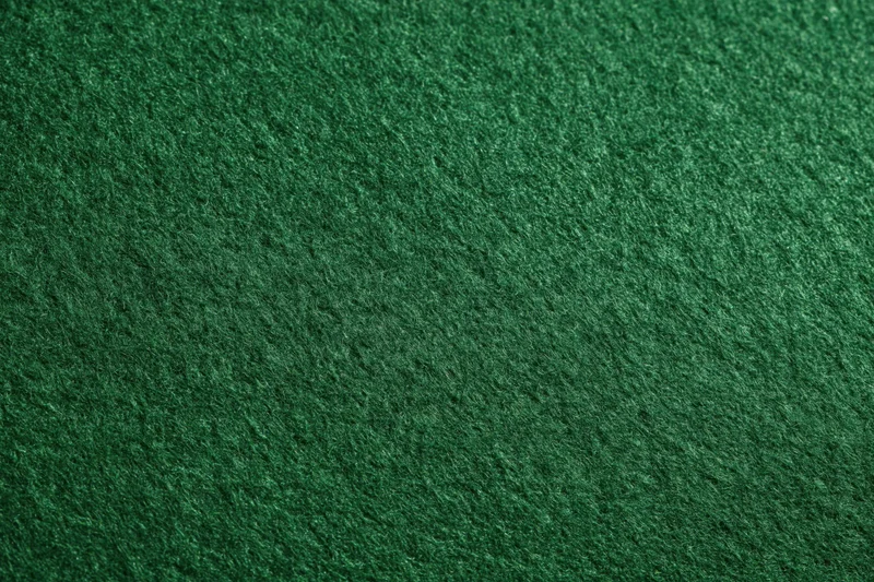 Close-up of dark green felt fabric surface filling the frame