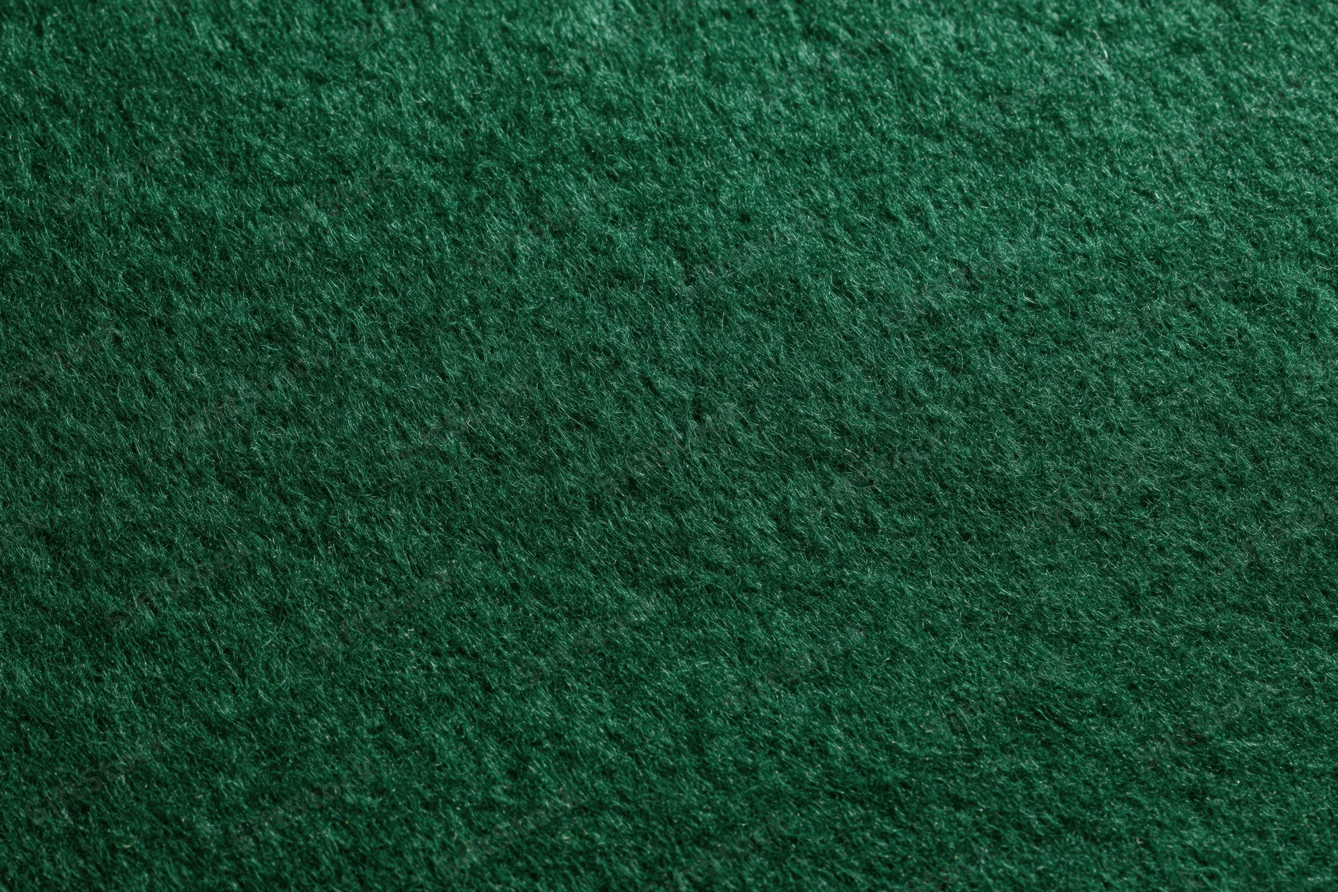 Close-up of dark green felt fabric surface filling the frame