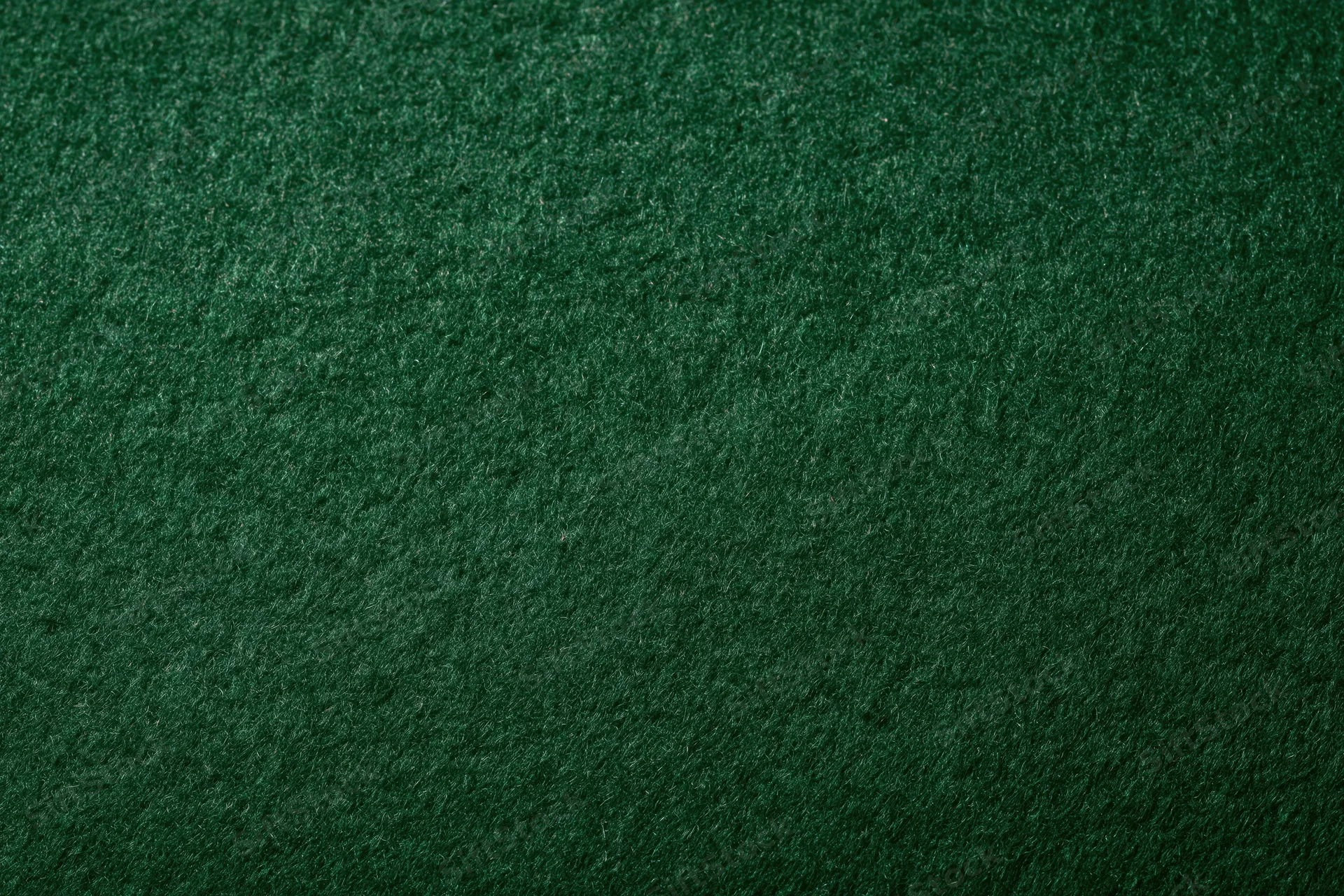 Close-up of dark green felt fabric surface filling the frame