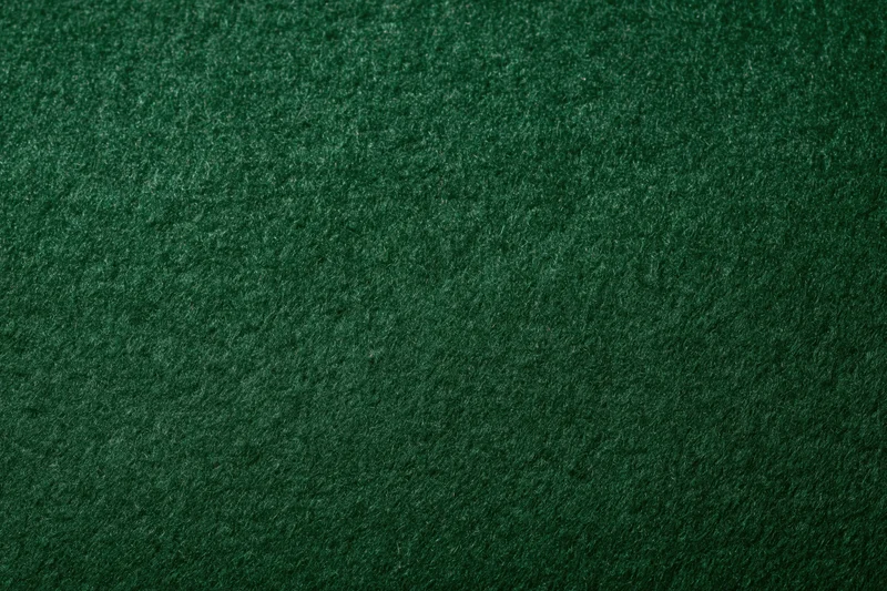 Close-up of dark green felt fabric surface filling the frame