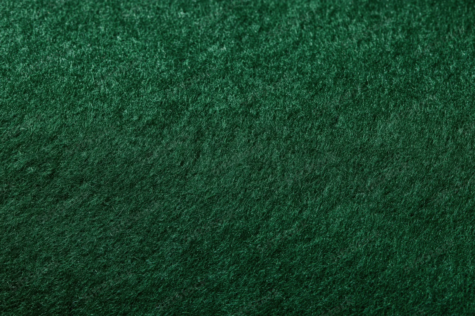 Close-up of dark green felt fabric surface filling the frame