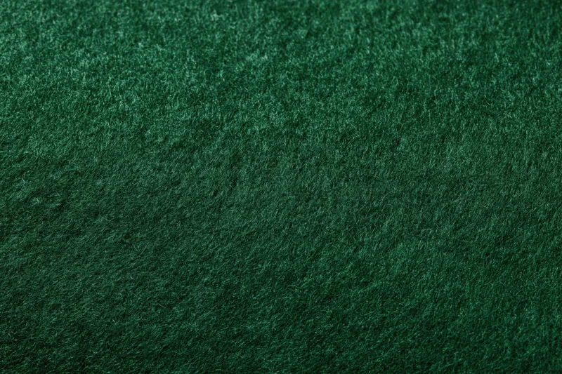 Close-up of dark green felt fabric surface filling the frame