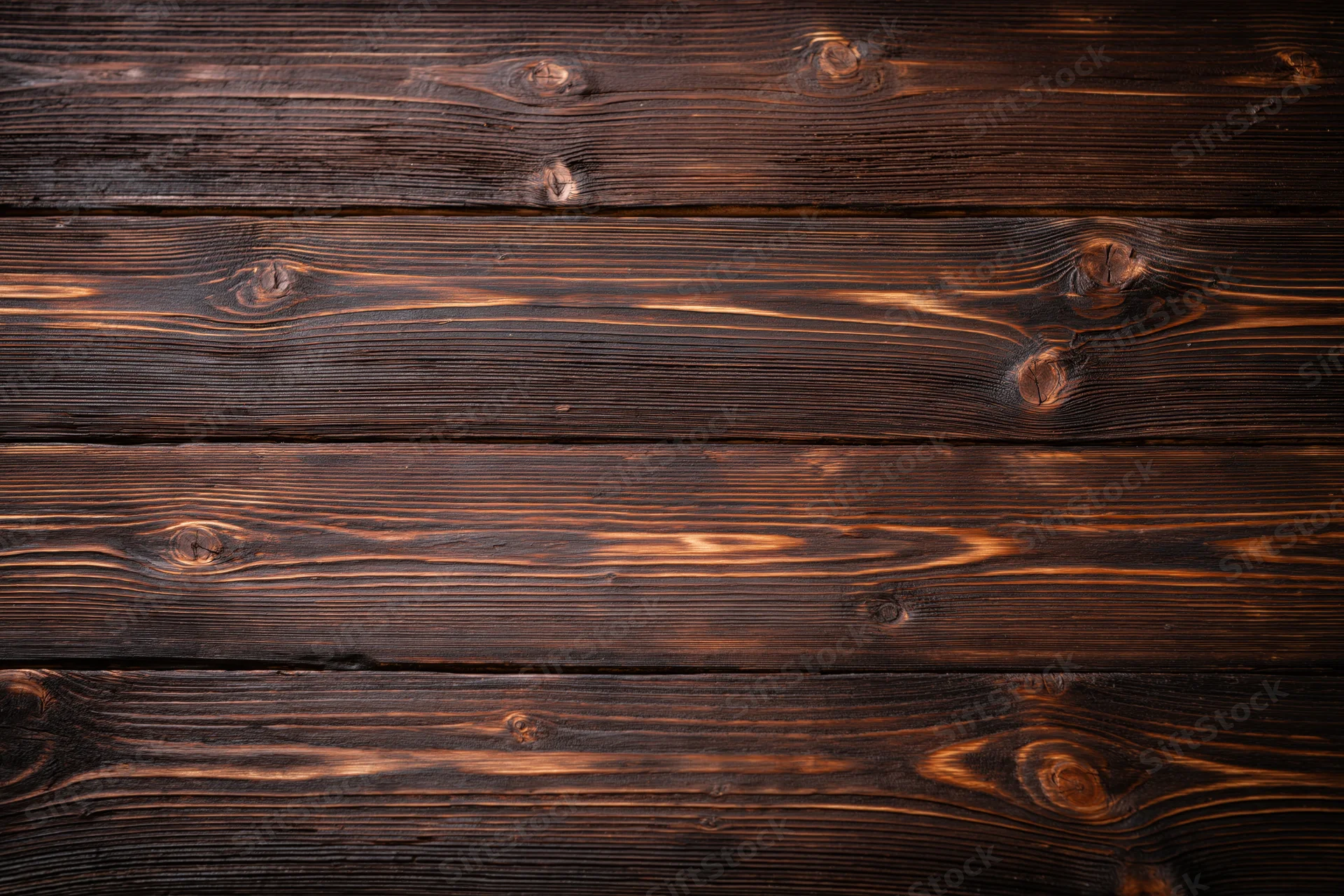 Dark stained horizontal wood planks forming a textured surface with visible grain and knots