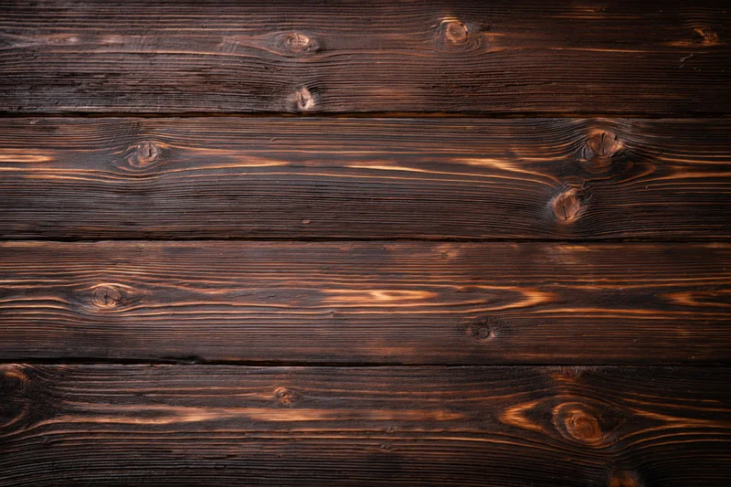 Dark stained horizontal wood planks forming a textured surface with visible grain and knots