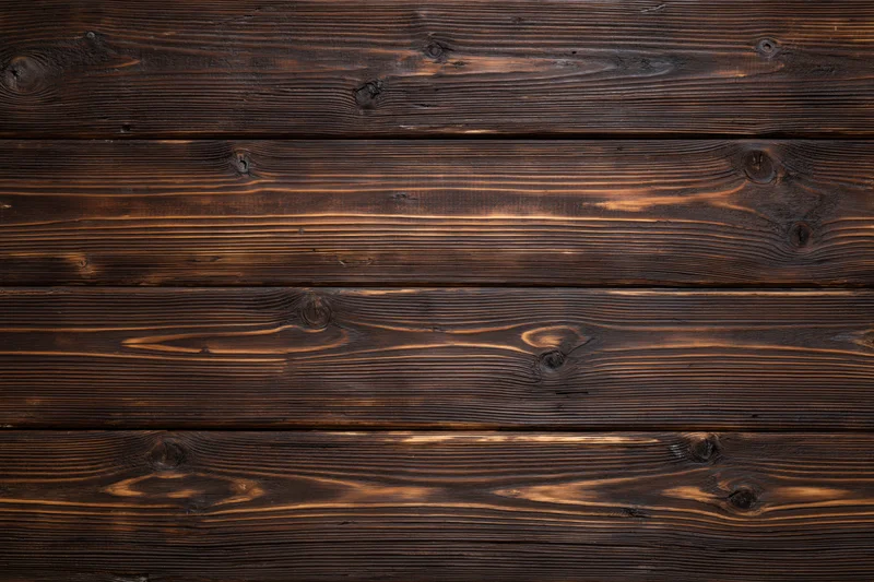 Dark stained horizontal wood planks forming a textured surface with visible grain and knots