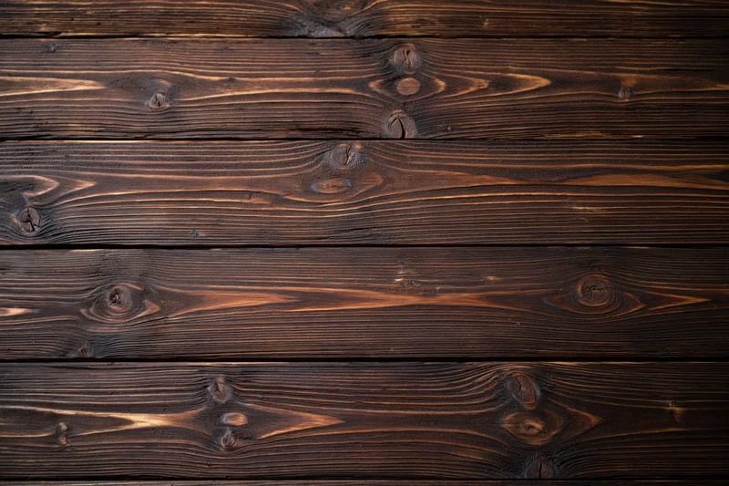 Dark stained horizontal wood planks forming a textured surface with visible grain and knots