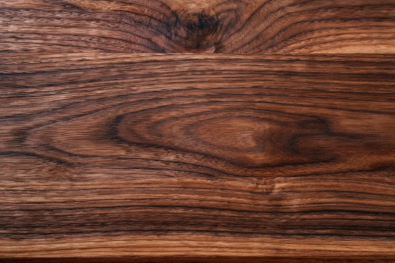 Close-up of dark walnut wood grain surface filling the frame