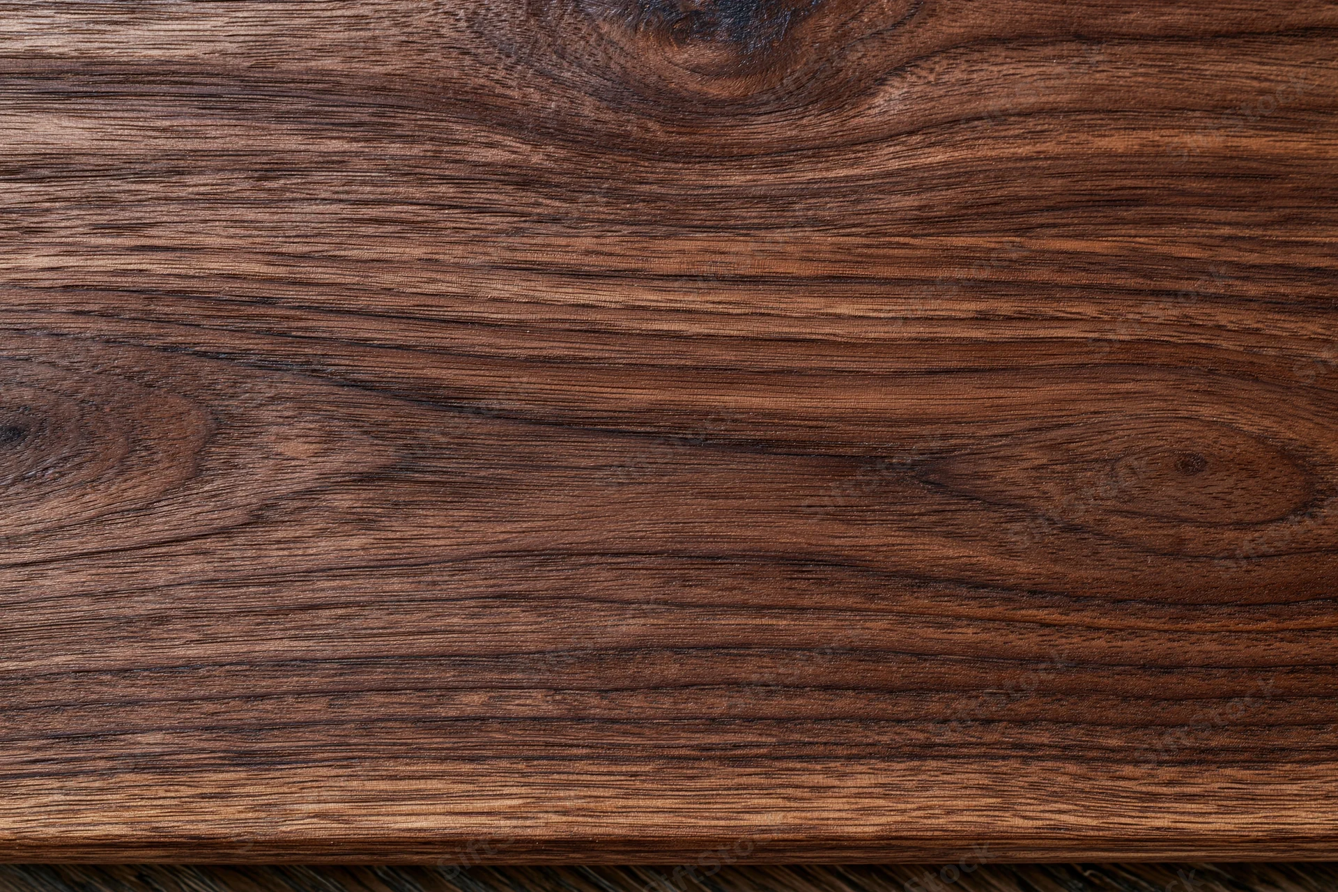 Close-up of dark walnut wood grain surface filling the frame