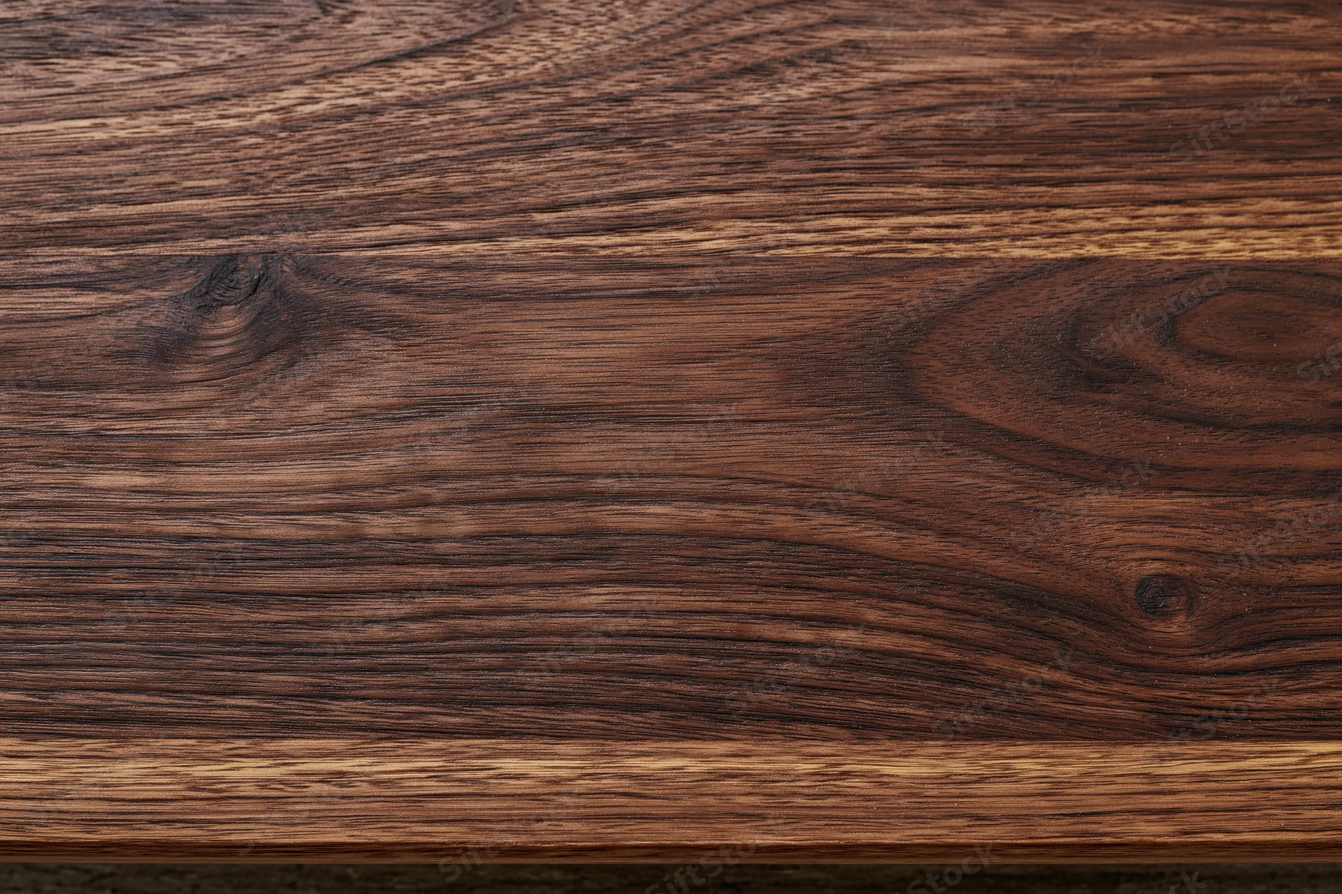 Close-up of dark walnut wood grain surface filling the frame