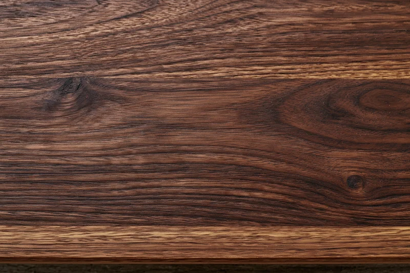 Close-up of dark walnut wood grain surface filling the frame