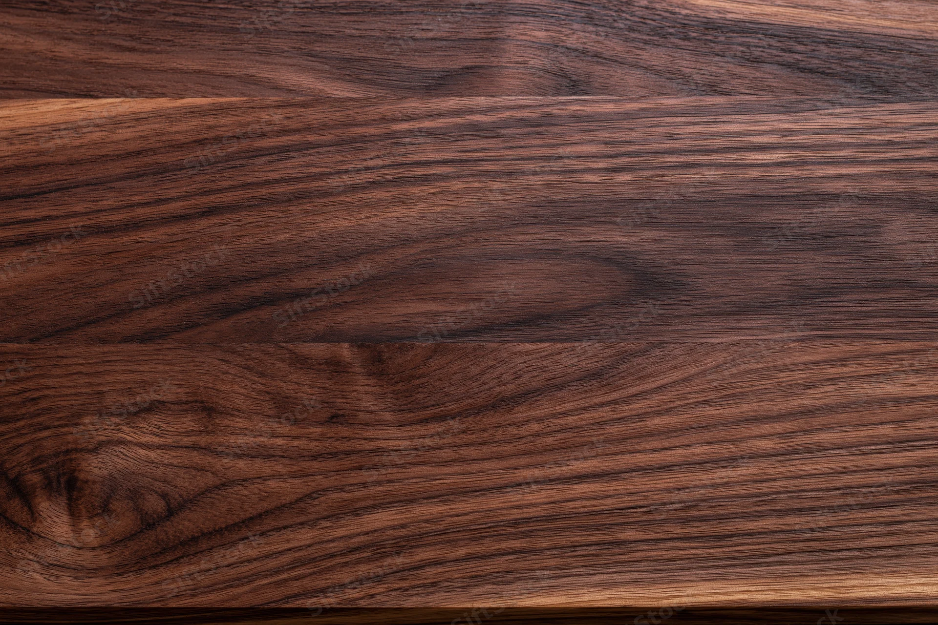 Close-up of dark walnut wood grain surface filling frame