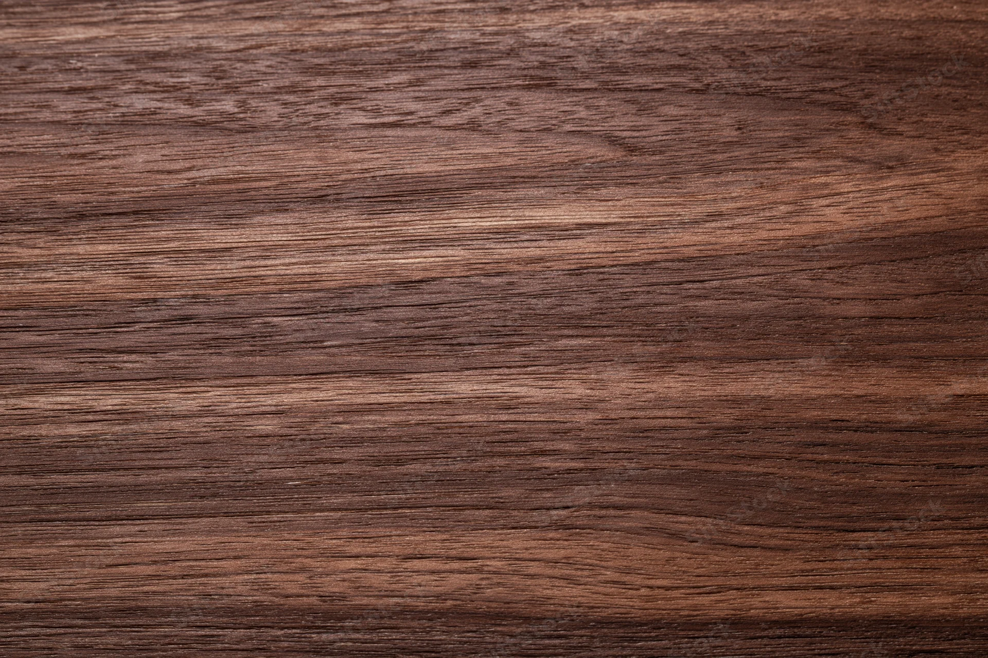 Close-up of dark walnut wood grain surface filling the frame
