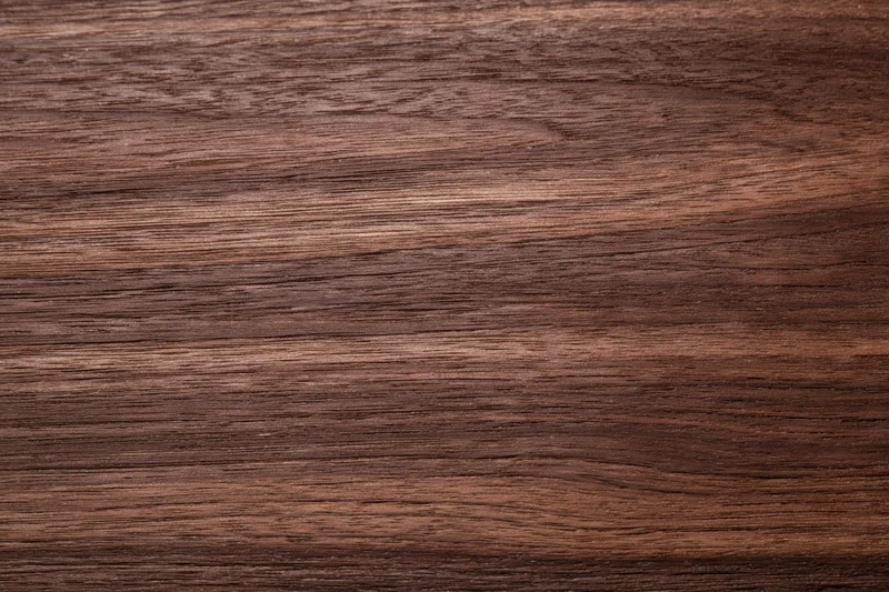 Close-up of dark walnut wood grain surface filling the frame