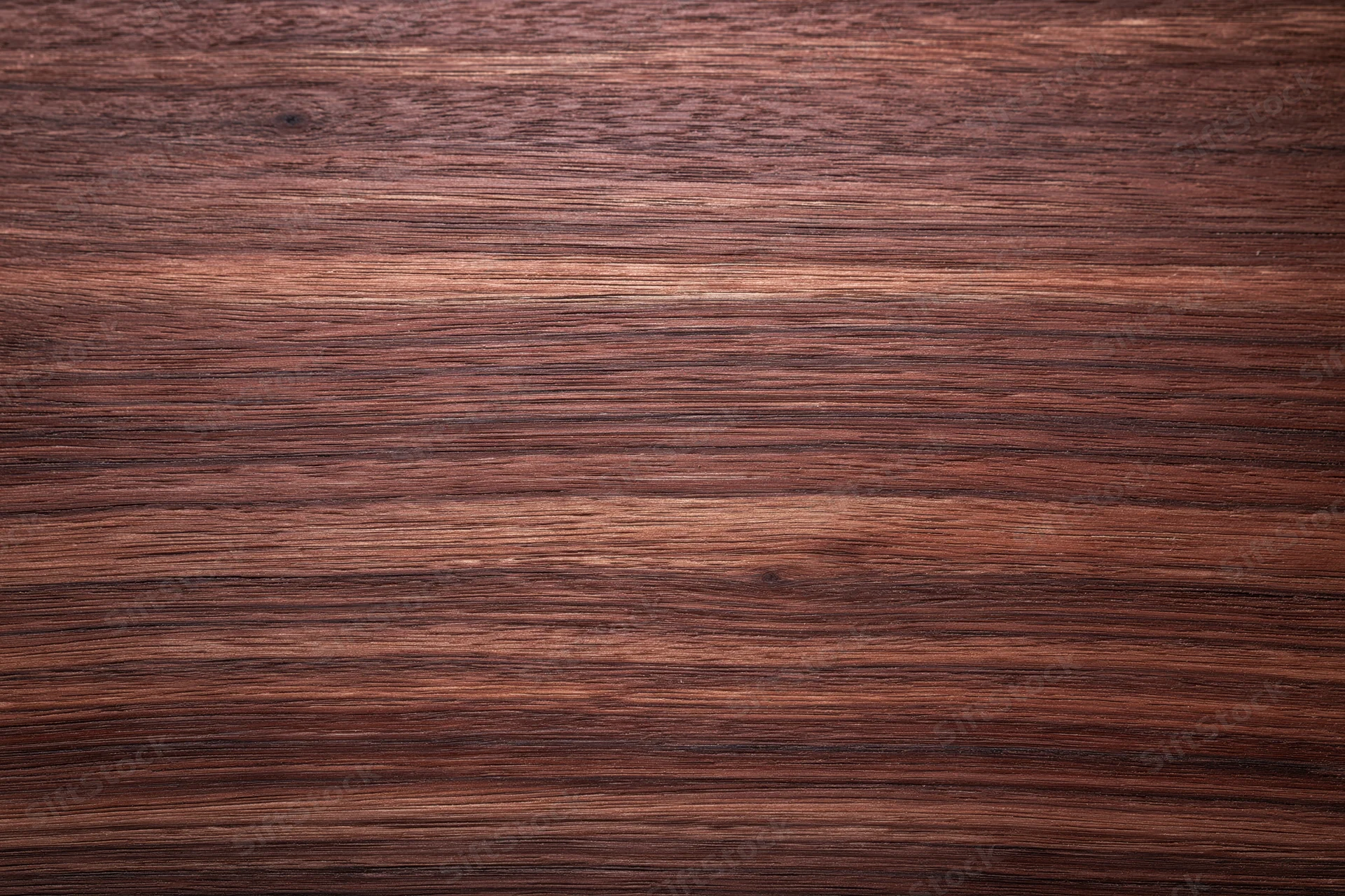 Close-up of dark walnut wood grain surface in flat lay arrangement