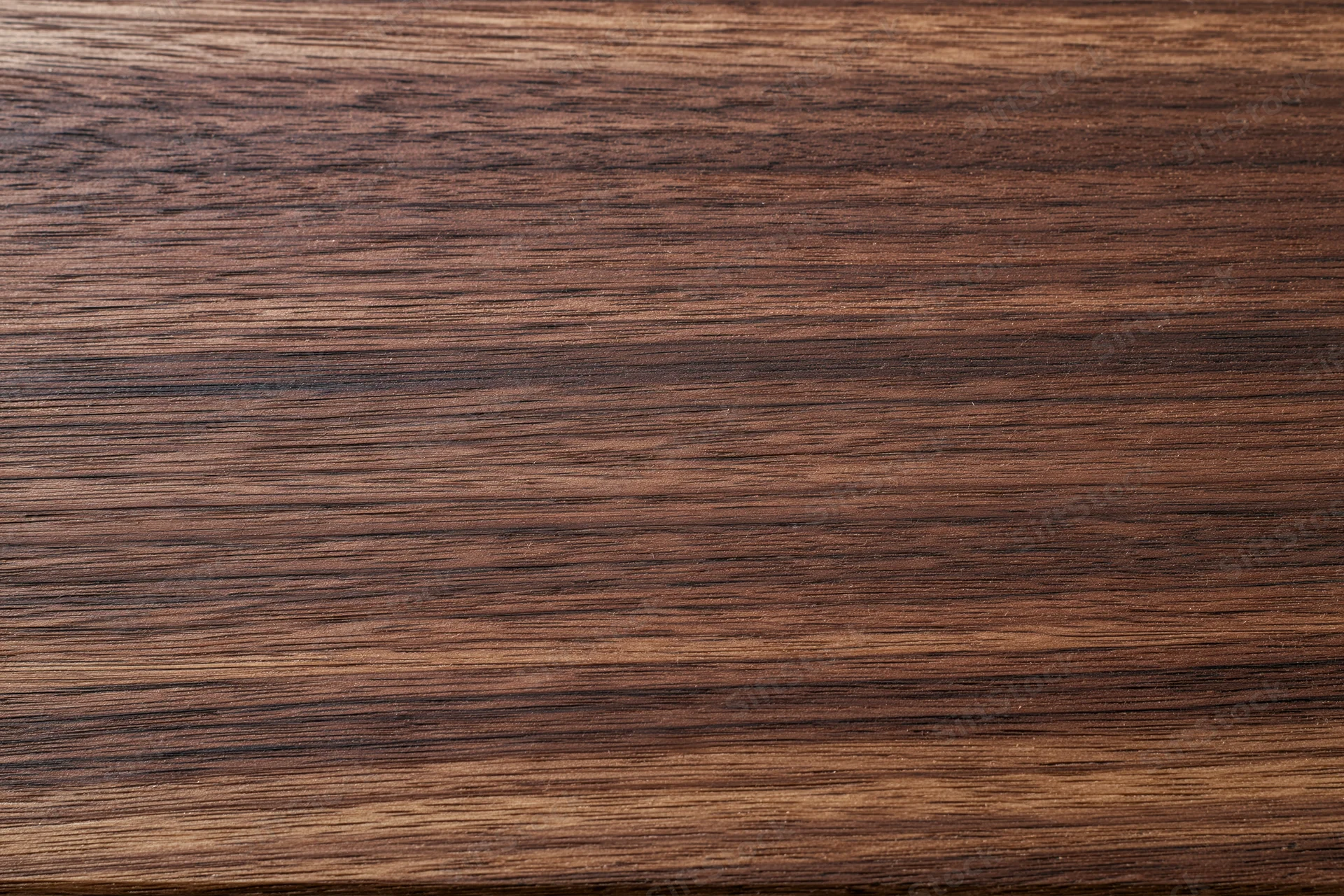 Close-up of dark walnut wood grain surface filling the frame
