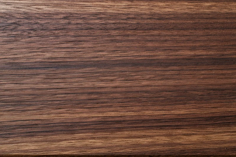 Close-up of dark walnut wood grain surface filling the frame