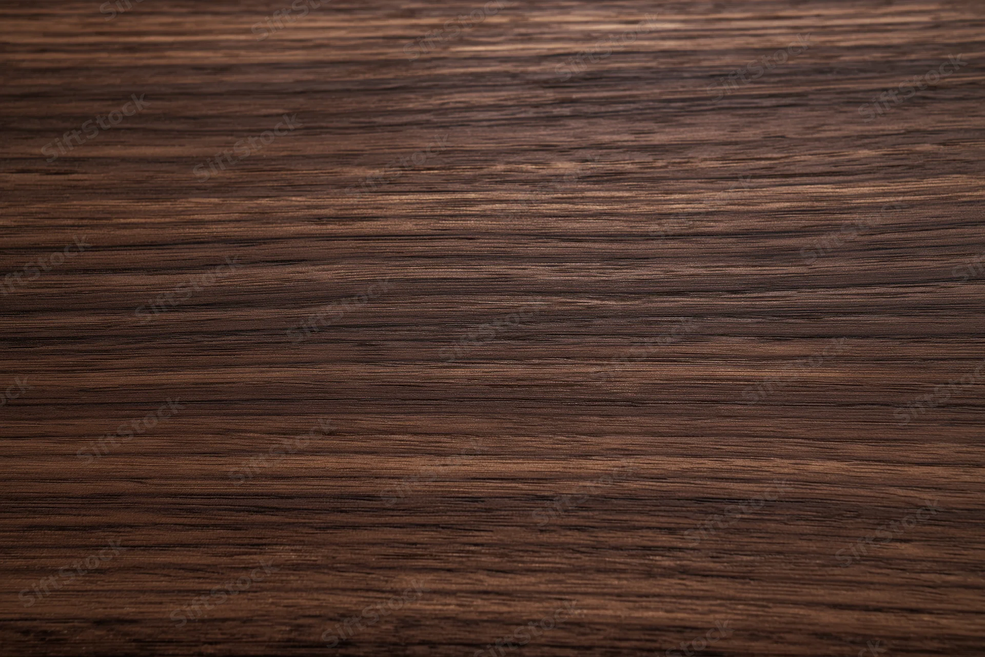 Close-up of dark walnut wood grain surface filling the frame