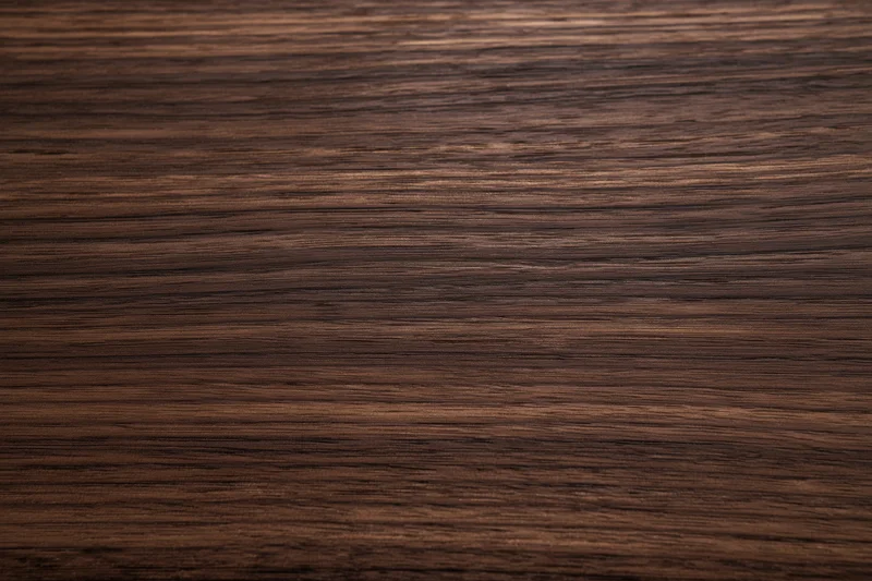 Close-up of dark walnut wood grain surface filling the frame