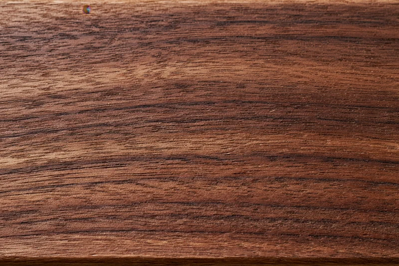 Close-up of dark walnut wood grain surface filling the frame