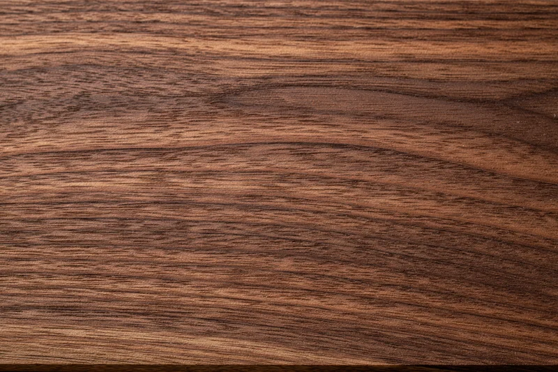 Close-up of dark walnut wood grain surface filling the frame
