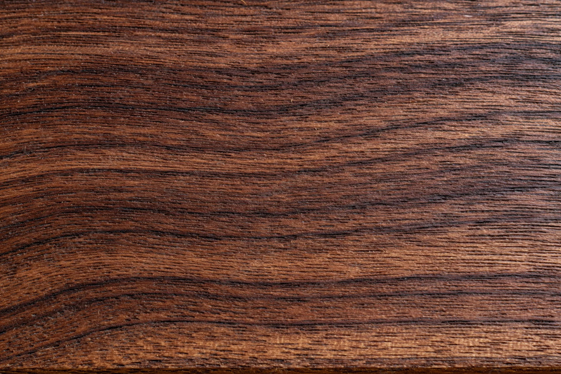 Close-up of dark walnut wood grain surface filling the frame