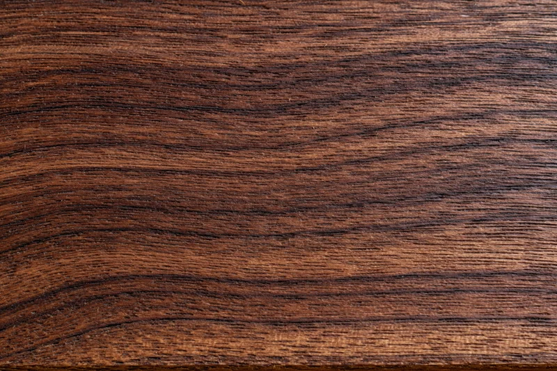 Close-up of dark walnut wood grain surface filling the frame