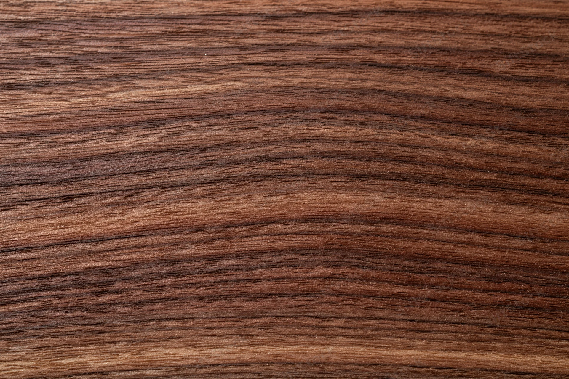 Close-up of dark walnut wood grain surface filling the frame