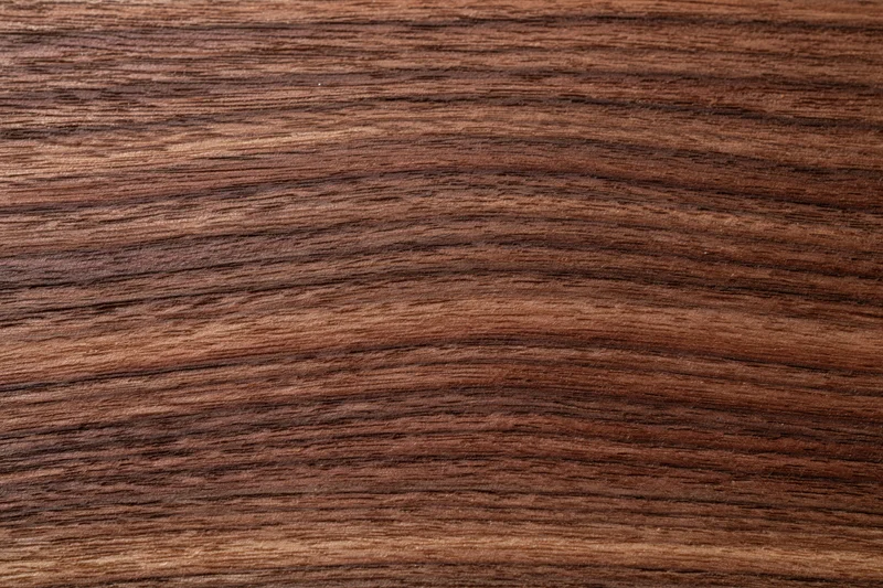 Close-up of dark walnut wood grain surface filling the frame