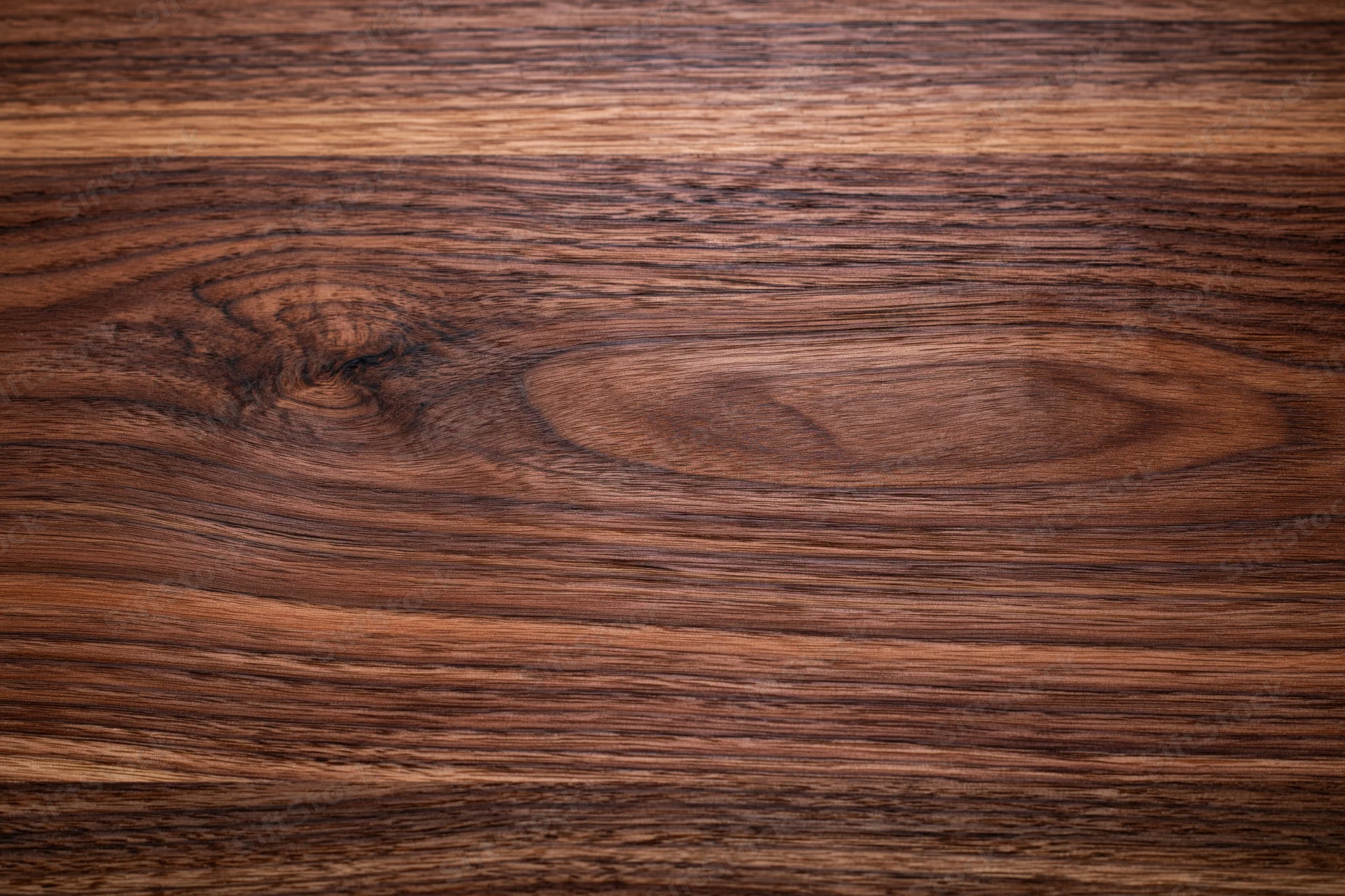 Close-up of dark walnut wood surface showing natural grain and texture