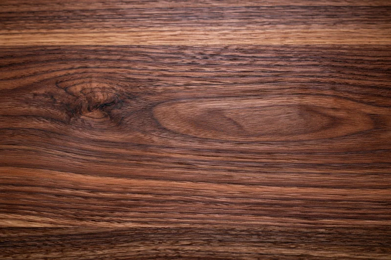 Close-up of dark walnut wood surface showing natural grain and texture