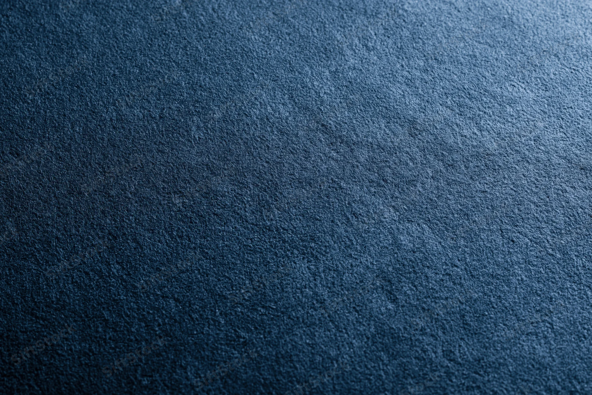 Close-up of deep navy blue suede fabric surface with matte texture