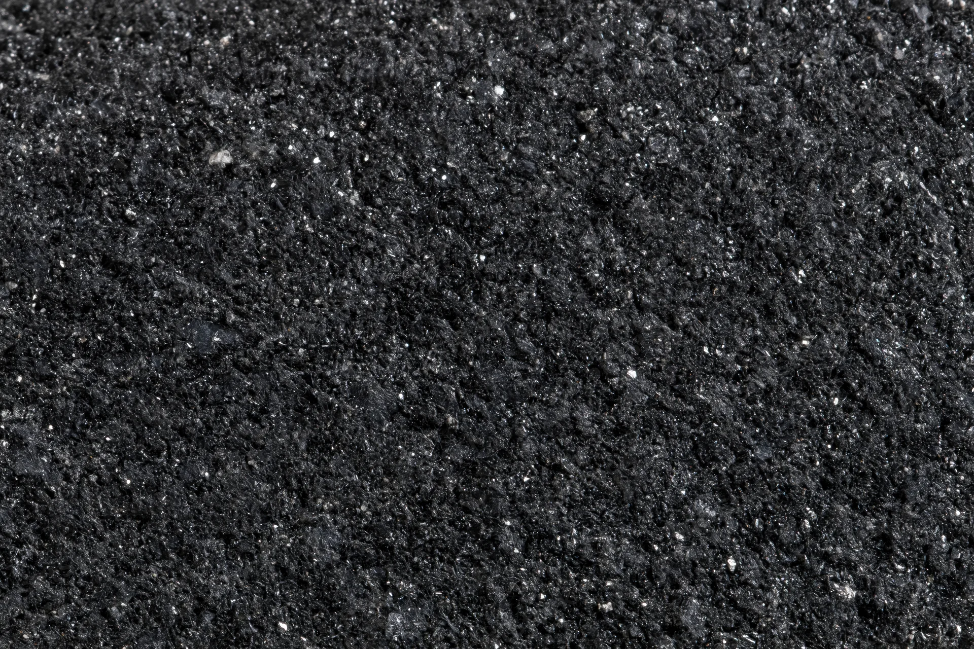 Close-up of polished black granite surface showing natural speckled texture