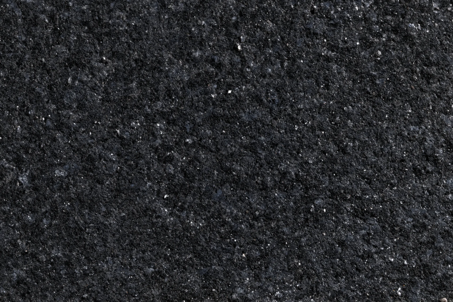 Close-up of polished black granite surface texture with speckled pattern