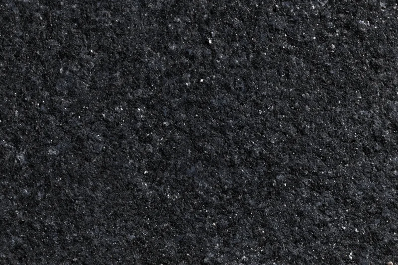 Close-up of polished black granite surface texture with speckled pattern
