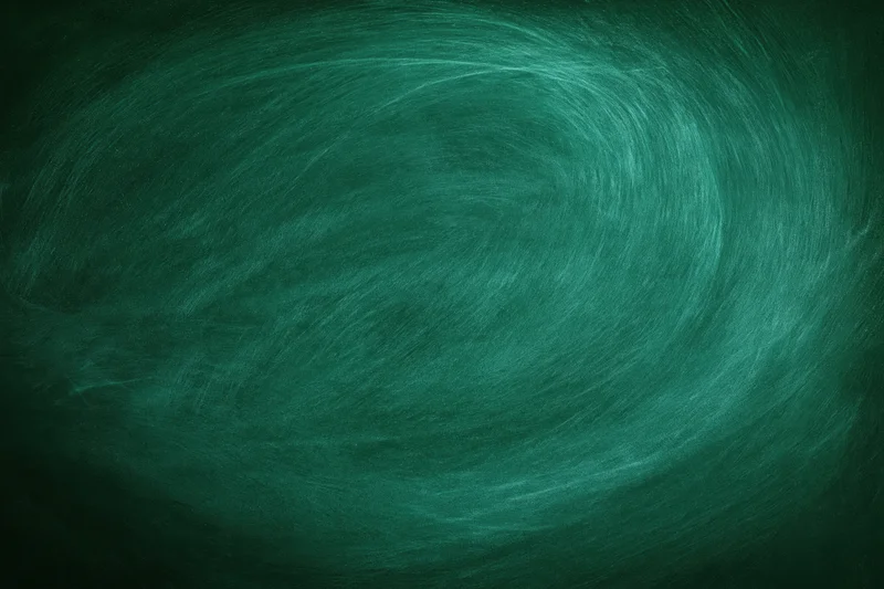 Close-up of blank green chalkboard surface with swirling texture and soft lighting