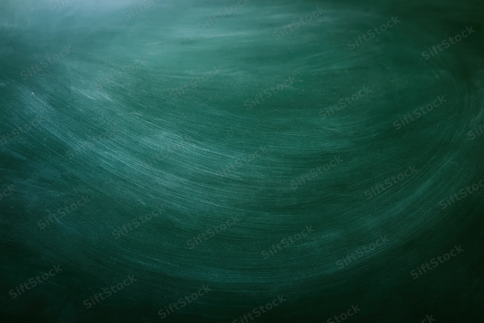 Close-up of a blank green chalkboard surface with smudged texture and swirl patterns, suitable for educational or academic use