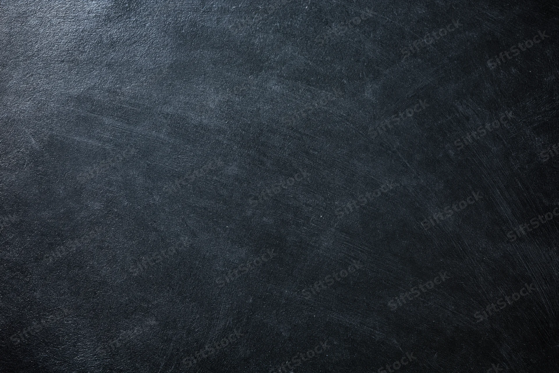Close-up of a dark charcoal textured surface with subtle grain and matte finish